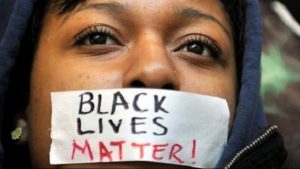 A Young Lady Dramatically Remains Silent in a Stoic Display of Support of "Black Lives Matter"